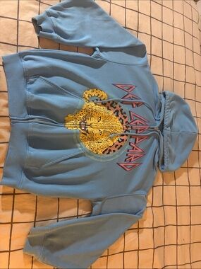 H&M def leppard Divided Light Blue Zip-Up Hoodie with Yellow Leopard Graphic